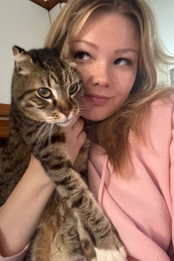 A Mirabella's nurse cuddling a cat at home